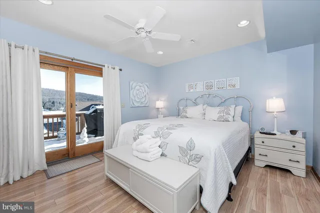 a bedroom with a large bed and a window