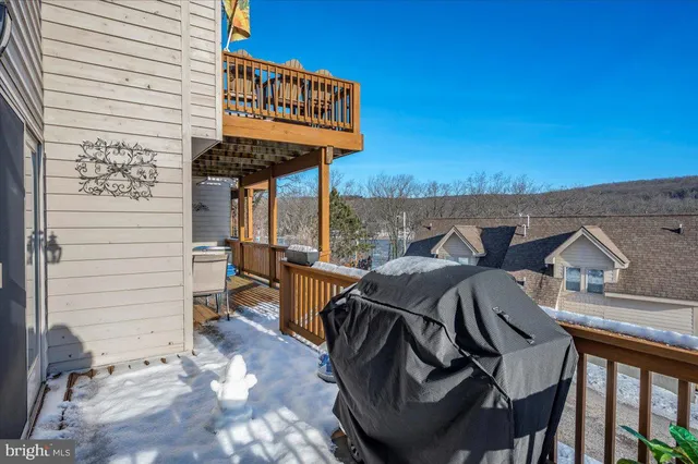 a view of a patio with table and chairs with wooden floor and fence