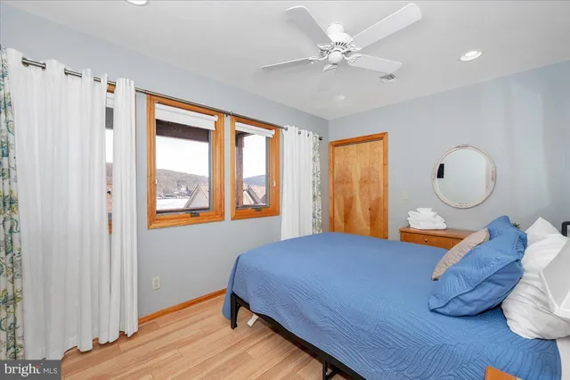 a bedroom with a bed and wooden floor