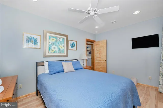 a bedroom with a large bed and a tv