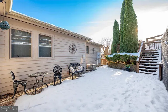 a view of a chairs and table in backyard