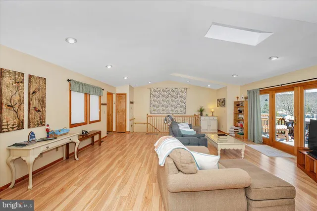 a living room with furniture and large windows