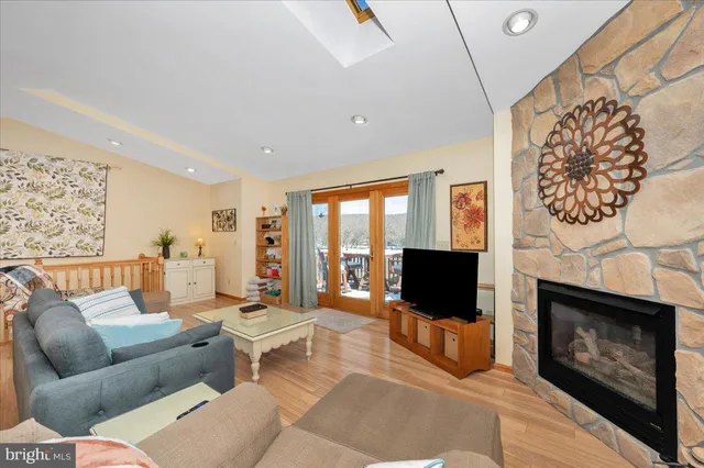 a living room with furniture a flat screen tv and a fireplace