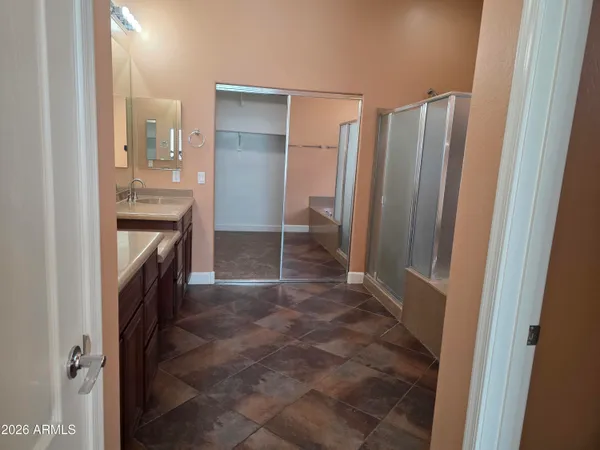 a bathroom with a double vanity sink and a mirror