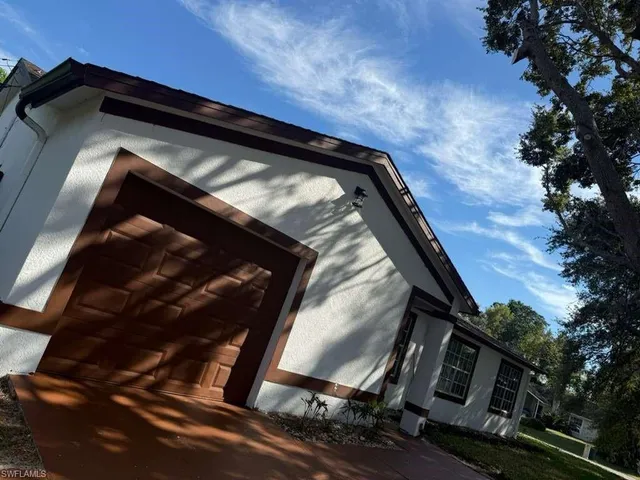 a view of a house with a tree