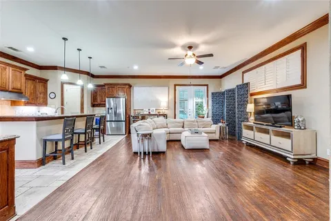 a kitchen with granite countertop a sink stove and refrigerator