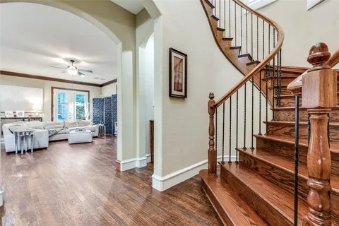a view of entryway and hall with wooden floor
