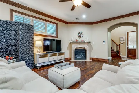 a living room with furniture fireplace and flat screen tv
