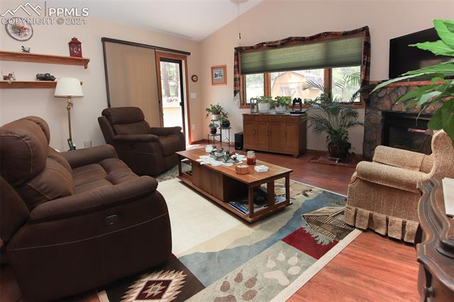 12020 Murphy Road Elbert, CO 80106 - Photo 14 of 39 This Family room was added in 2010! It has wood laminate flooring, a walk-out to the back deck and a gas burning fireplace.