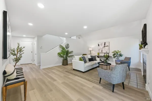 a living room with furniture potted plant and a fireplace