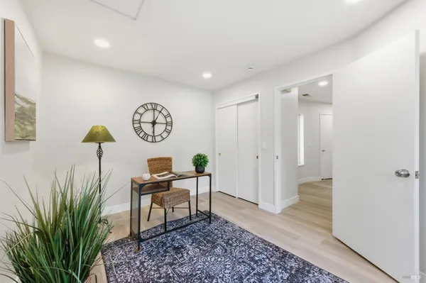 a living room with furniture and a potted plant