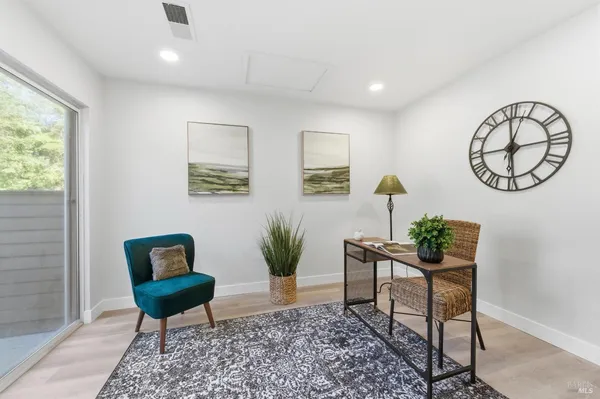 a bathroom with a granite countertop sink a toilet and a mirror