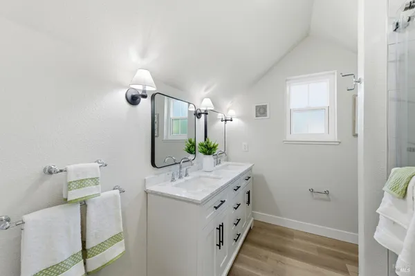 a bathroom with a tub sink and mirror