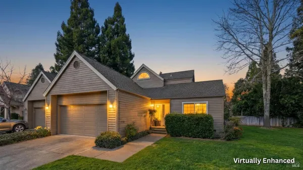 a front view of a house with a yard and outdoor seating