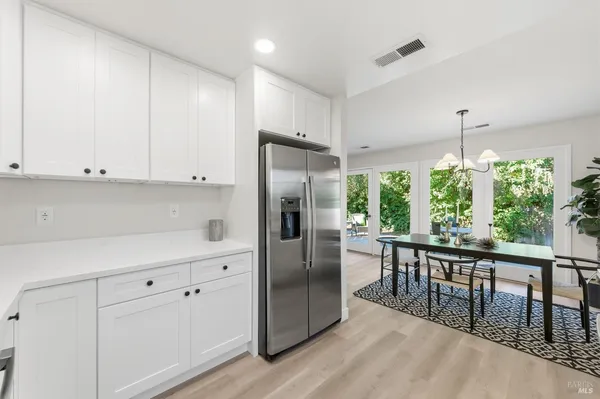a kitchen with a sink stove top oven and refrigerator