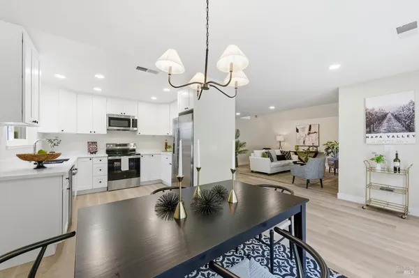 a kitchen with a table and chairs in it