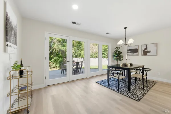 a living room with furniture a fireplace and a floor to ceiling window