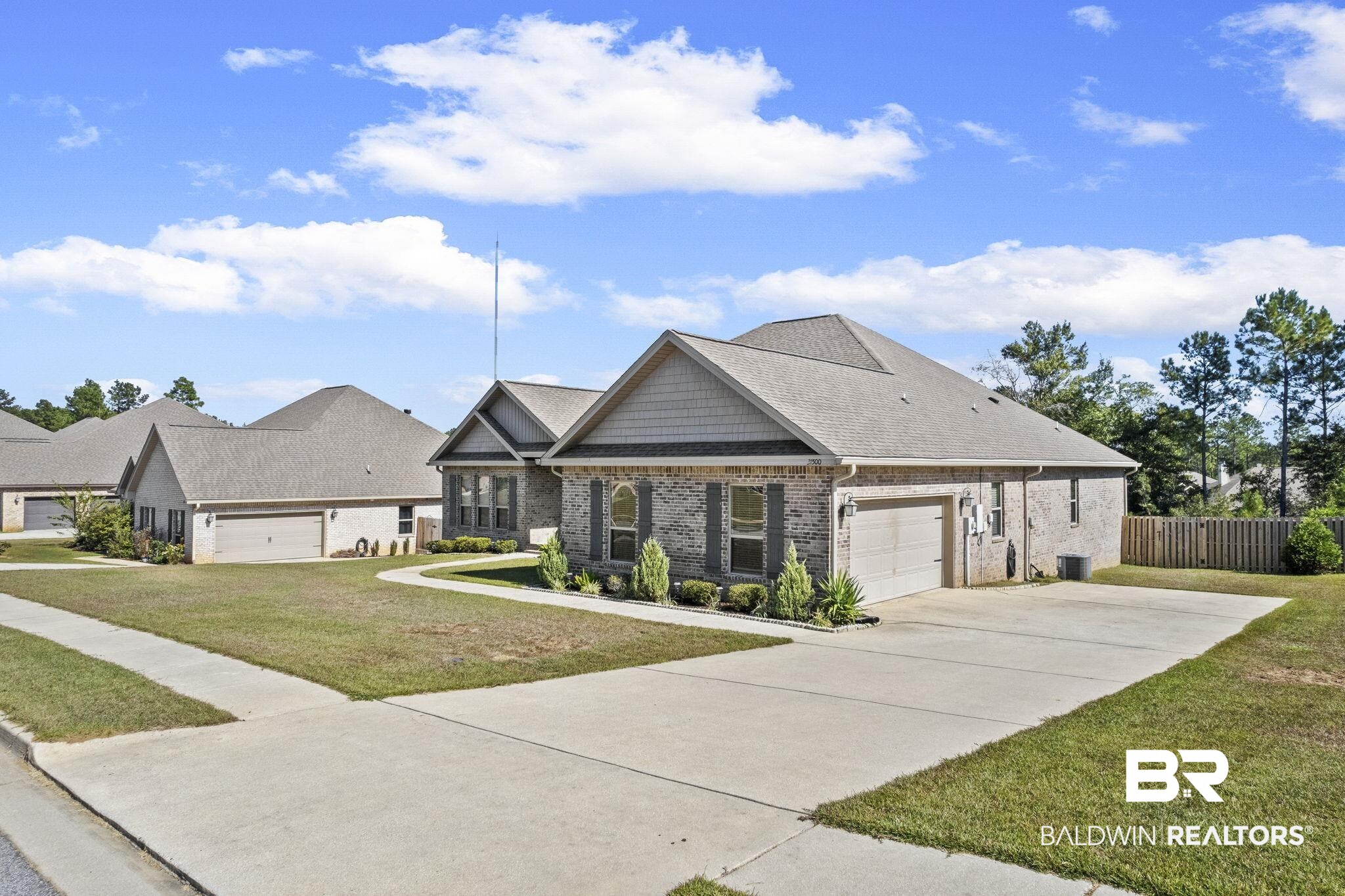 31500 Spoonbill Road Daphne, AL 36527 - Photo 61 of 85 View of front of property featuring a garage and a front yard