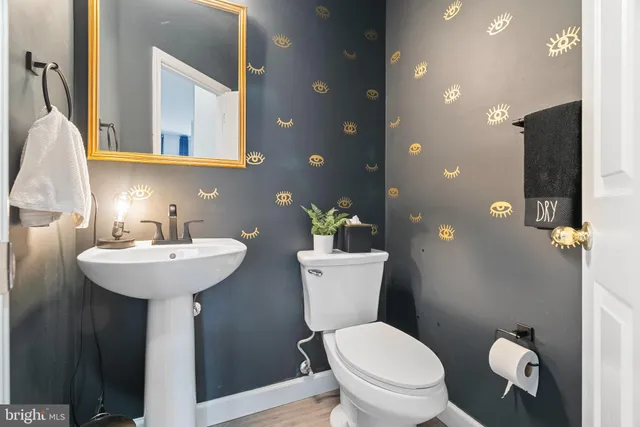 a bathroom with a toilet sink and mirror