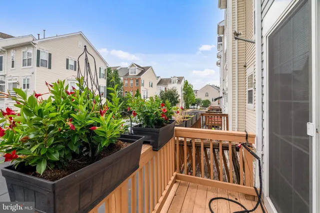 a view of a balcony with chairs and a potted plant