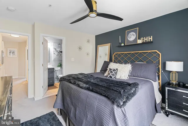 a bedroom with a bed and a lamp