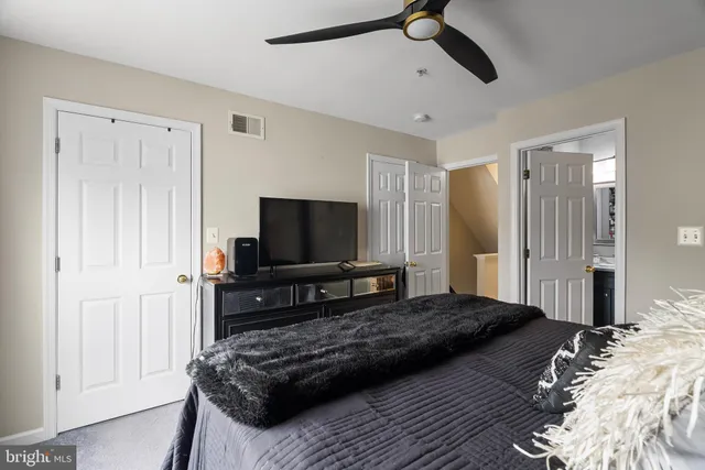 a bedroom with a bed and a flat screen television