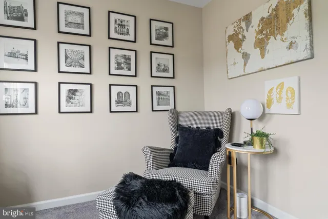 a living room with furniture and wall painting