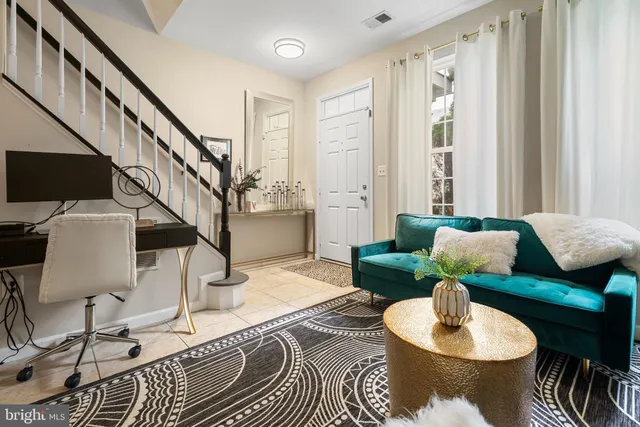 a living room with furniture and a lamp