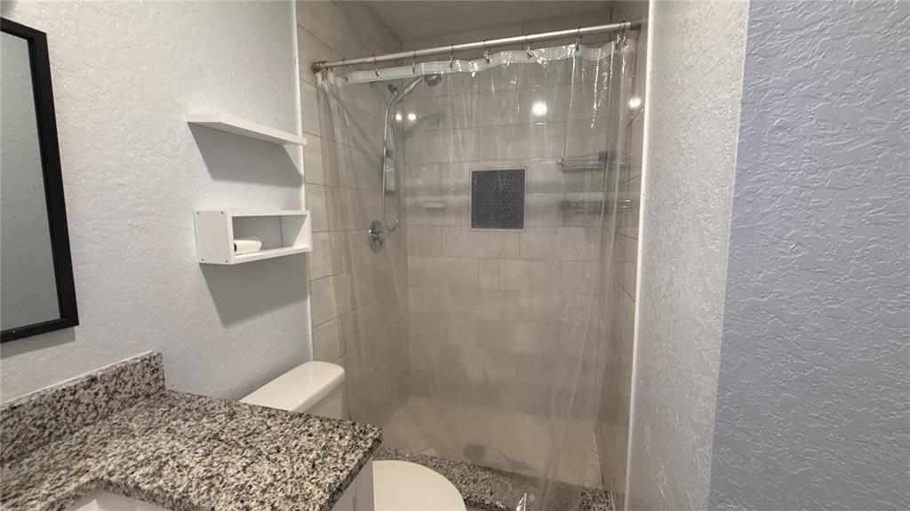8106 Wichita Way Tampa, FL 33619 - Photo 12 of 21 a bathroom with a shower and a toilet