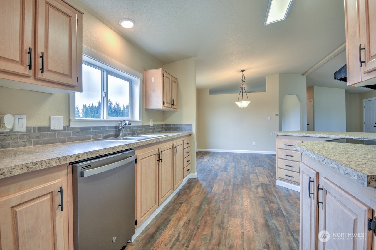 19212 Old Ranch Lane Southwest Rochester, WA 98579 - Photo 12 of 33 a kitchen with granite countertop a sink stove and cabinets