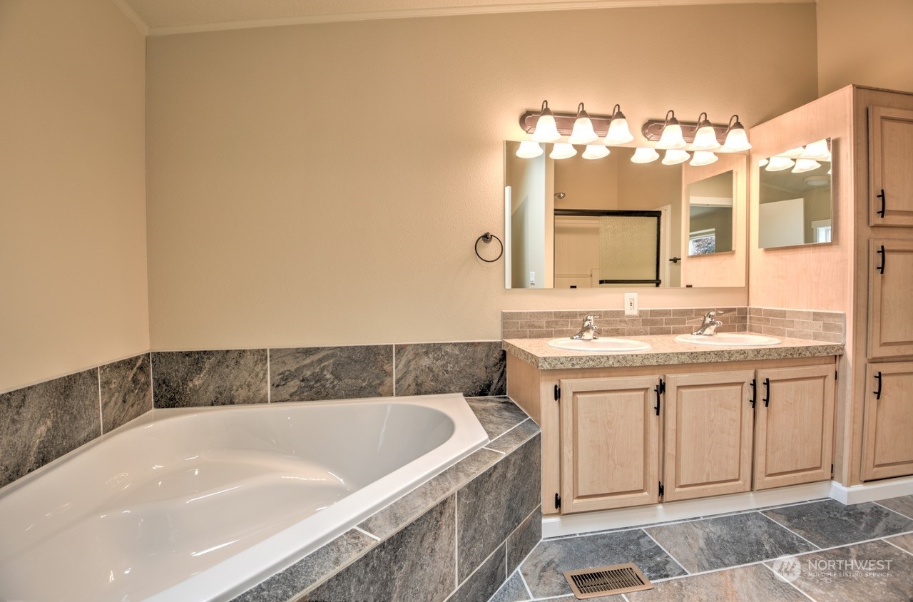 19212 Old Ranch Lane Southwest Rochester, WA 98579 - Photo 17 of 33 a bathroom with a tub sink and mirror