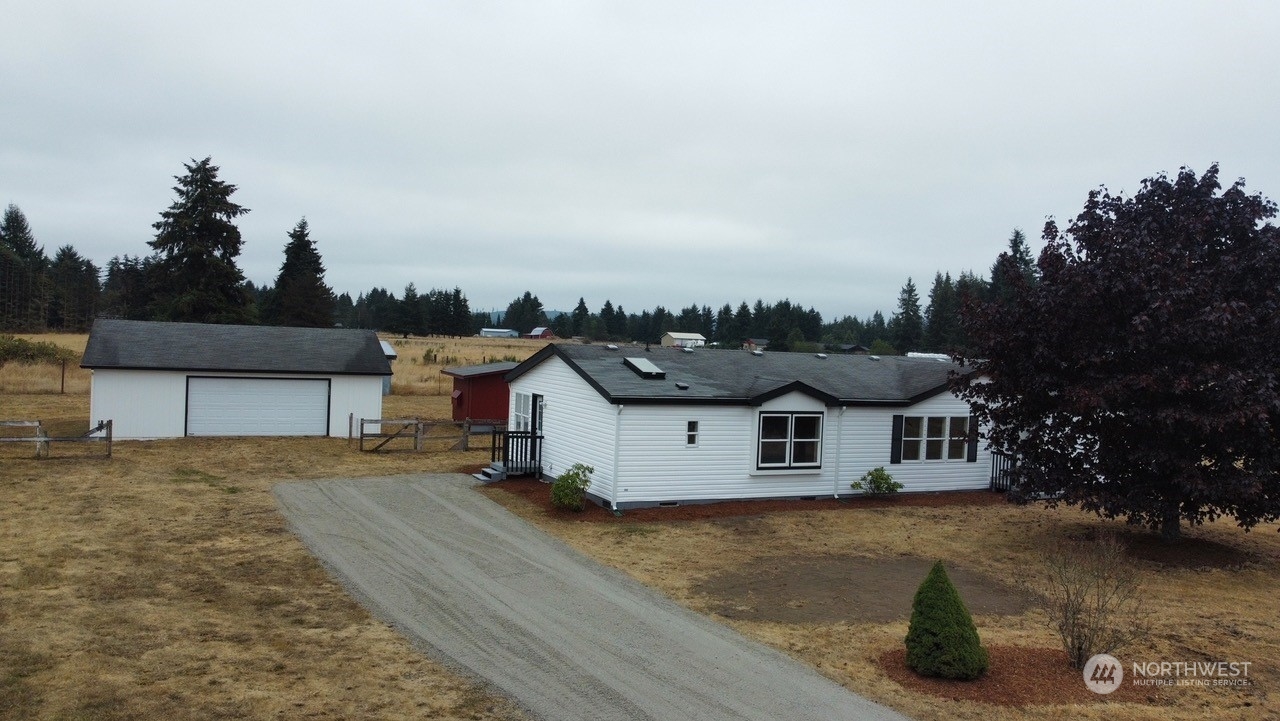 19212 Old Ranch Lane Southwest Rochester, WA 98579 - Photo 2 of 33 a front view of a house with a yard