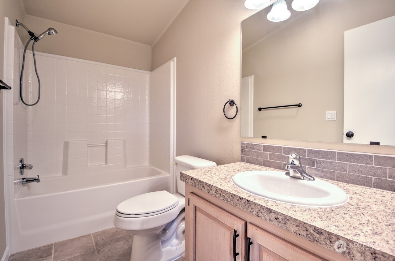19212 Old Ranch Lane Southwest Rochester, WA 98579 - Photo 22 of 33 a bathroom with a granite countertop sink toilet and shower