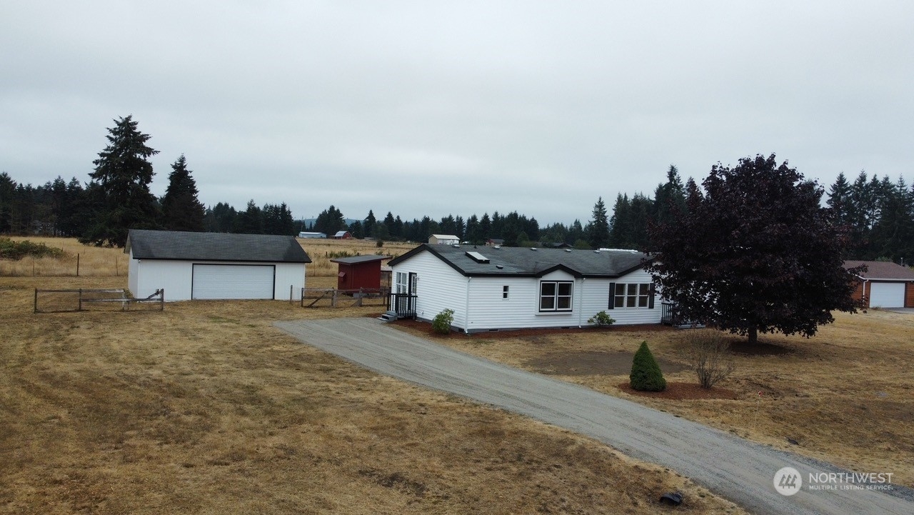 19212 Old Ranch Lane Southwest Rochester, WA 98579 - Photo 30 of 33 a view of a house with a yard and sitting area
