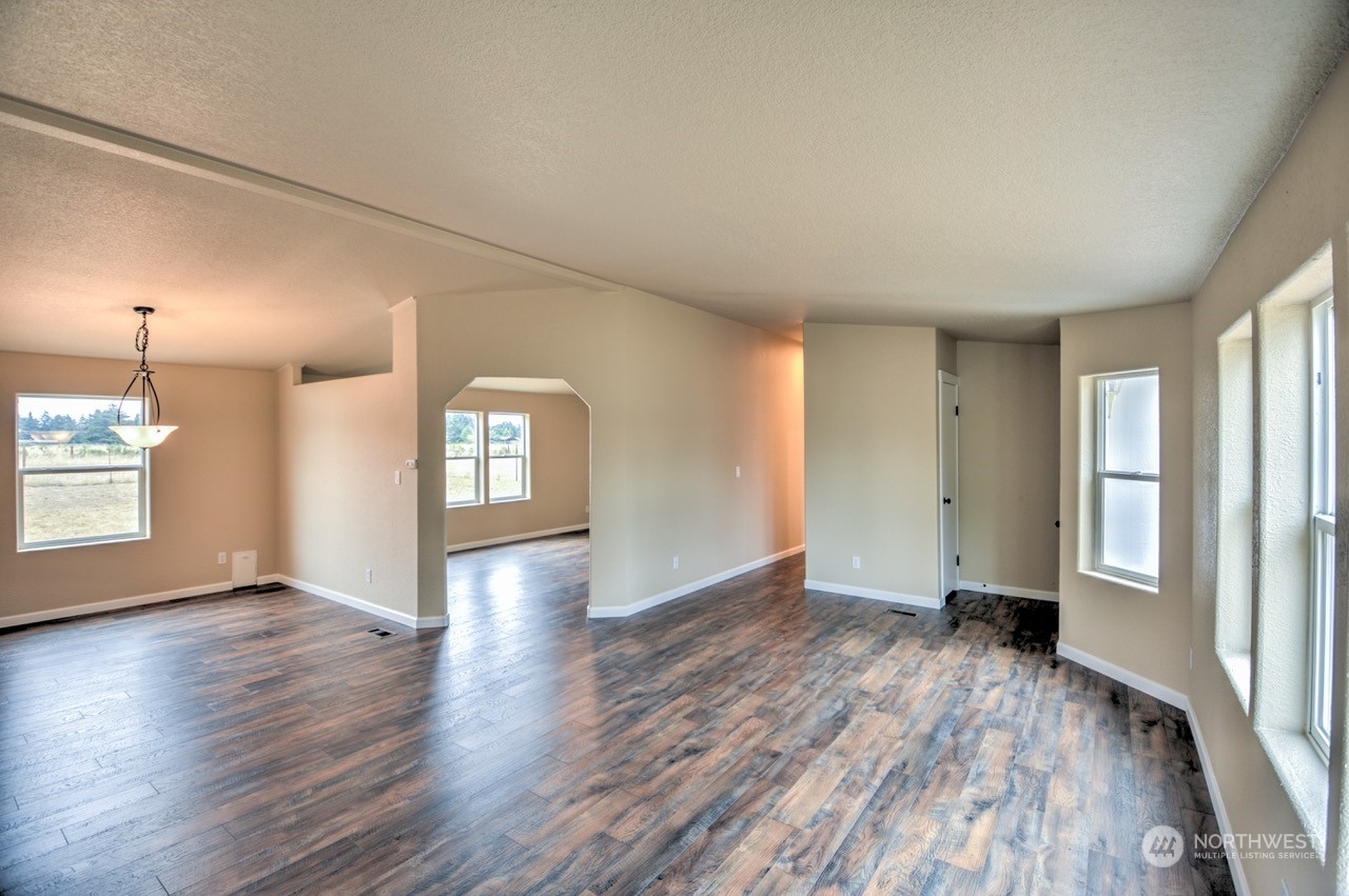19212 Old Ranch Lane Southwest Rochester, WA 98579 - Photo 5 of 33 a view of an empty room with window and wooden floor