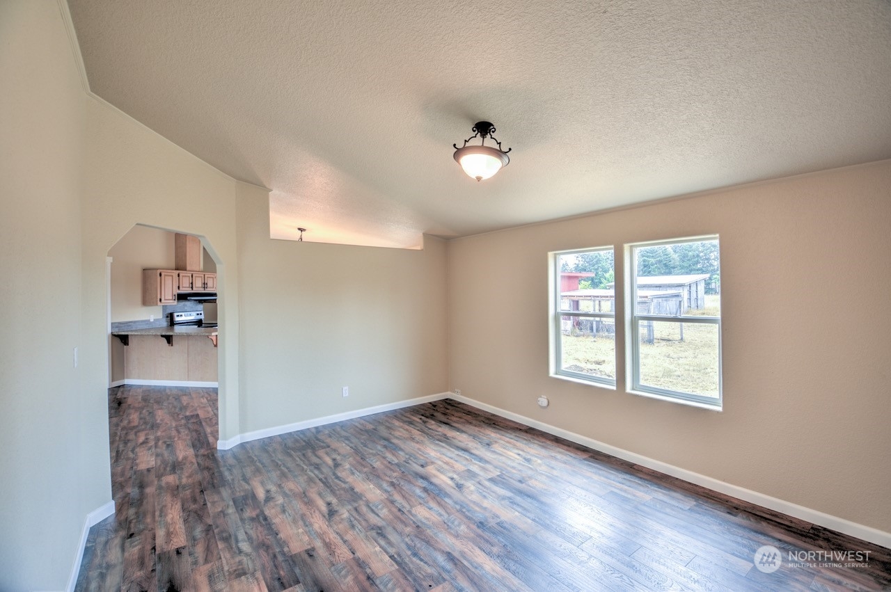 19212 Old Ranch Lane Southwest Rochester, WA 98579 - Photo 7 of 33 wooden floor in an empty room with a window