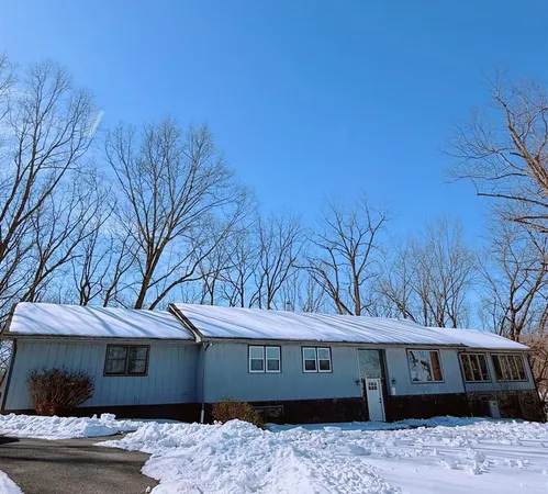 a front view of a houses with a yard