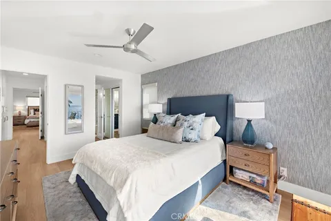 a bedroom with a large bed and a chandelier