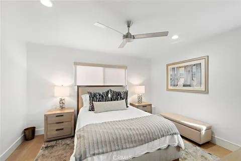 a bedroom with a bed and a night stand