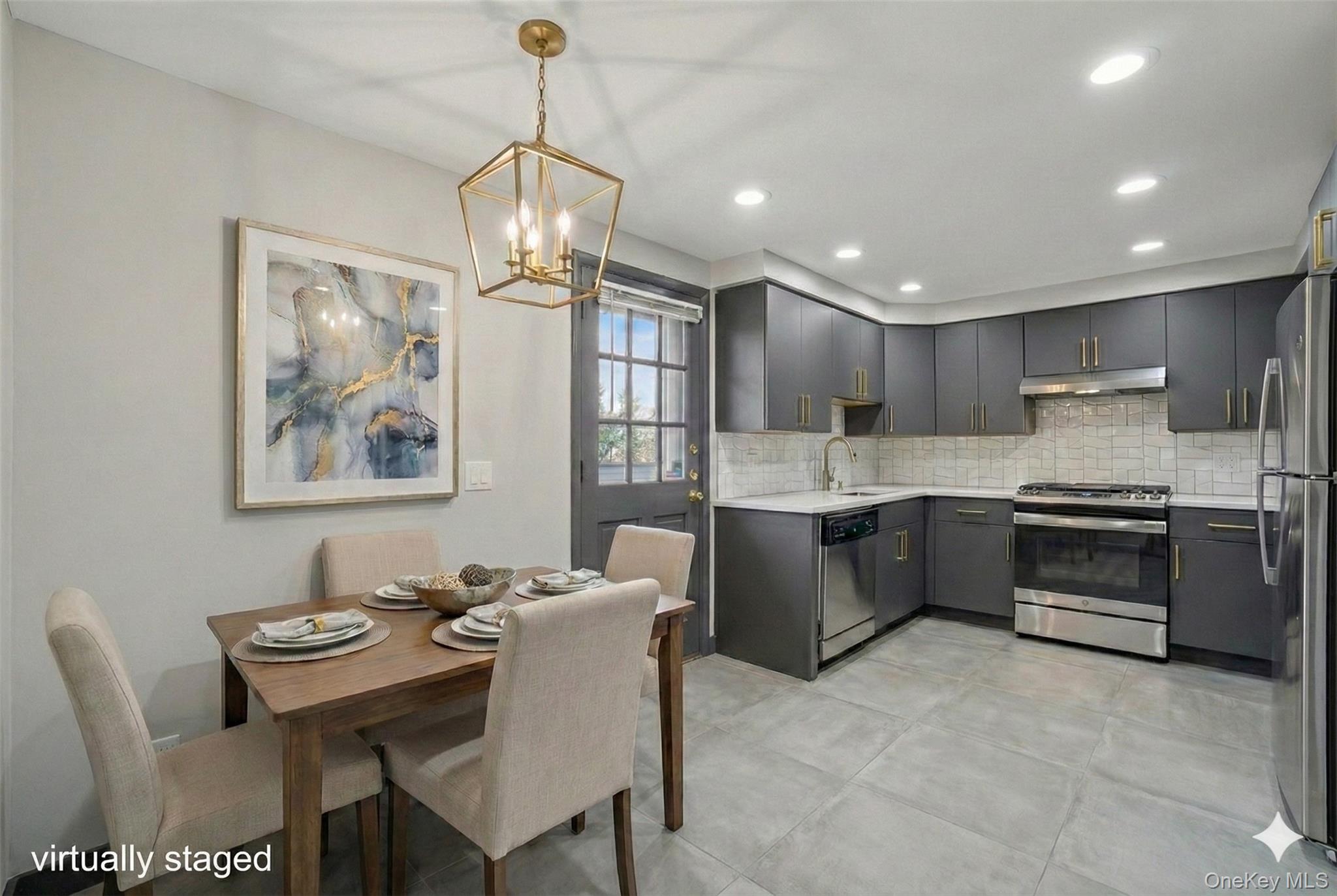 41 Devoe Street Dobbs Ferry, NY 10522 - Photo 11 of 28 a kitchen with stainless steel appliances granite countertop a stove a sink a microwave a dining table and chairs