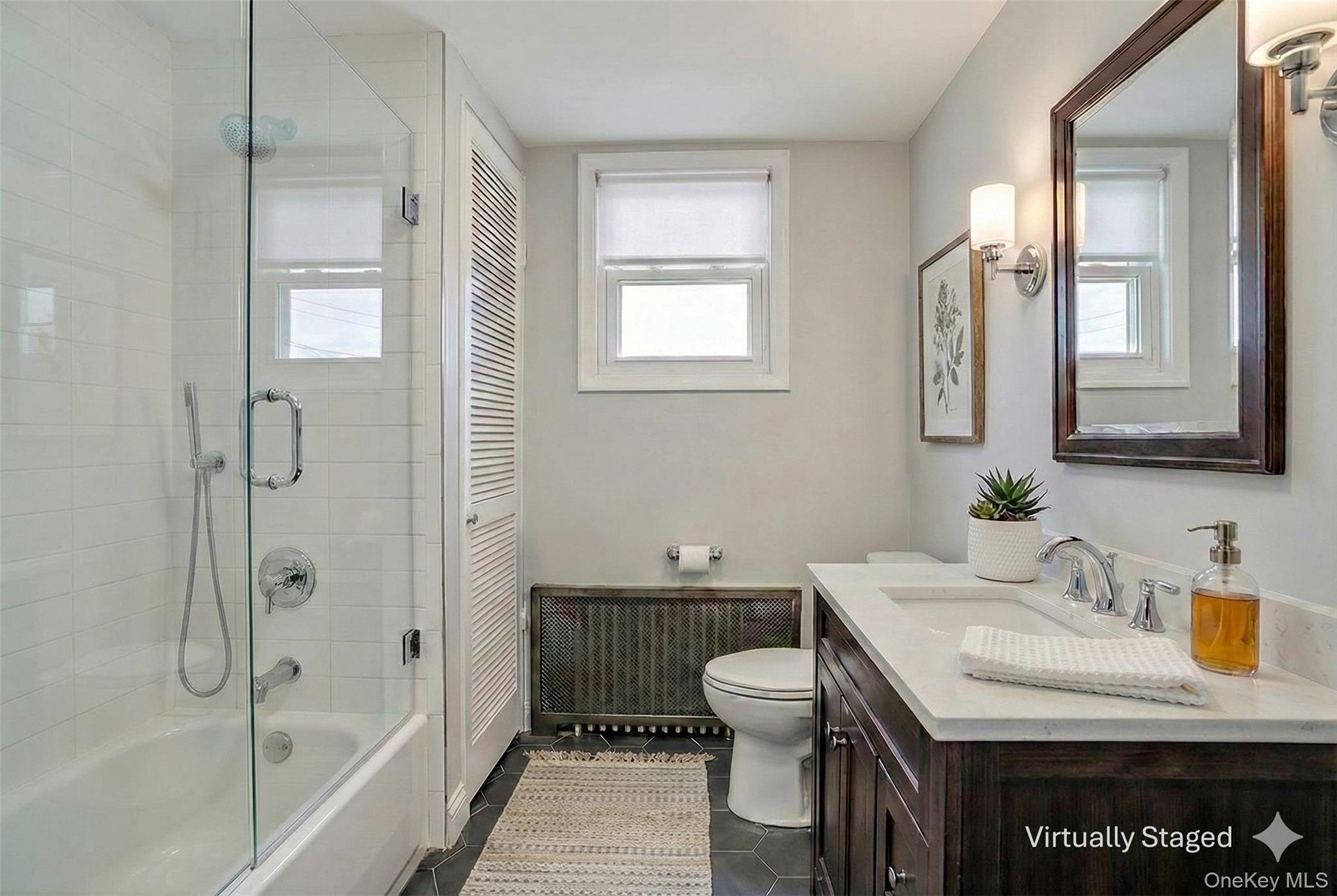 41 Devoe Street Dobbs Ferry, NY 10522 - Photo 19 of 28 a bathroom with a granite countertop sink a toilet and shower