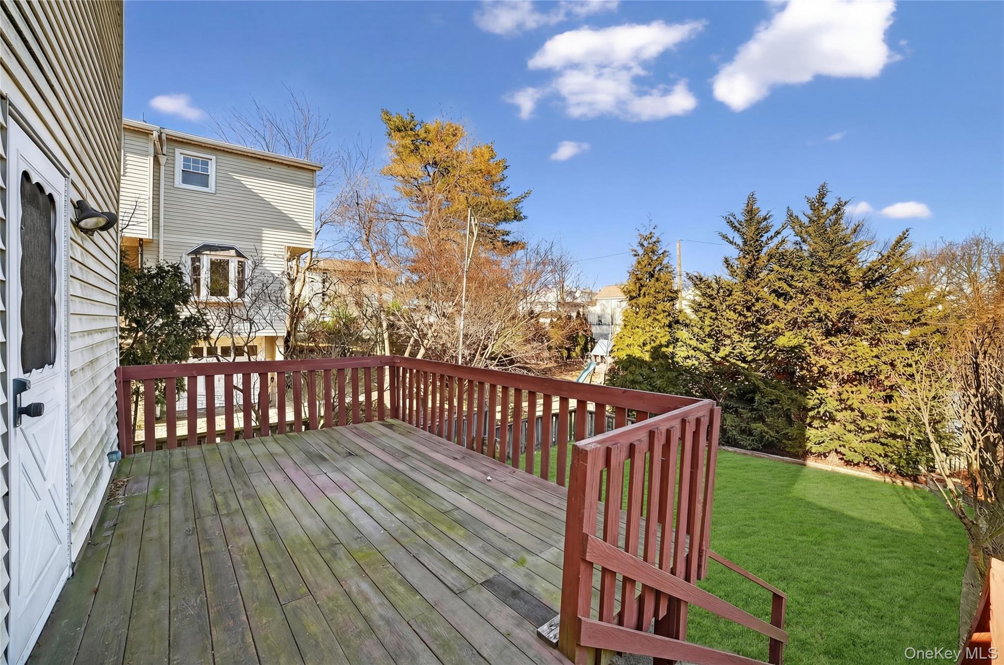 41 Devoe Street Dobbs Ferry, NY 10522 - Photo 23 of 28 a view of a wooden deck with a big yard