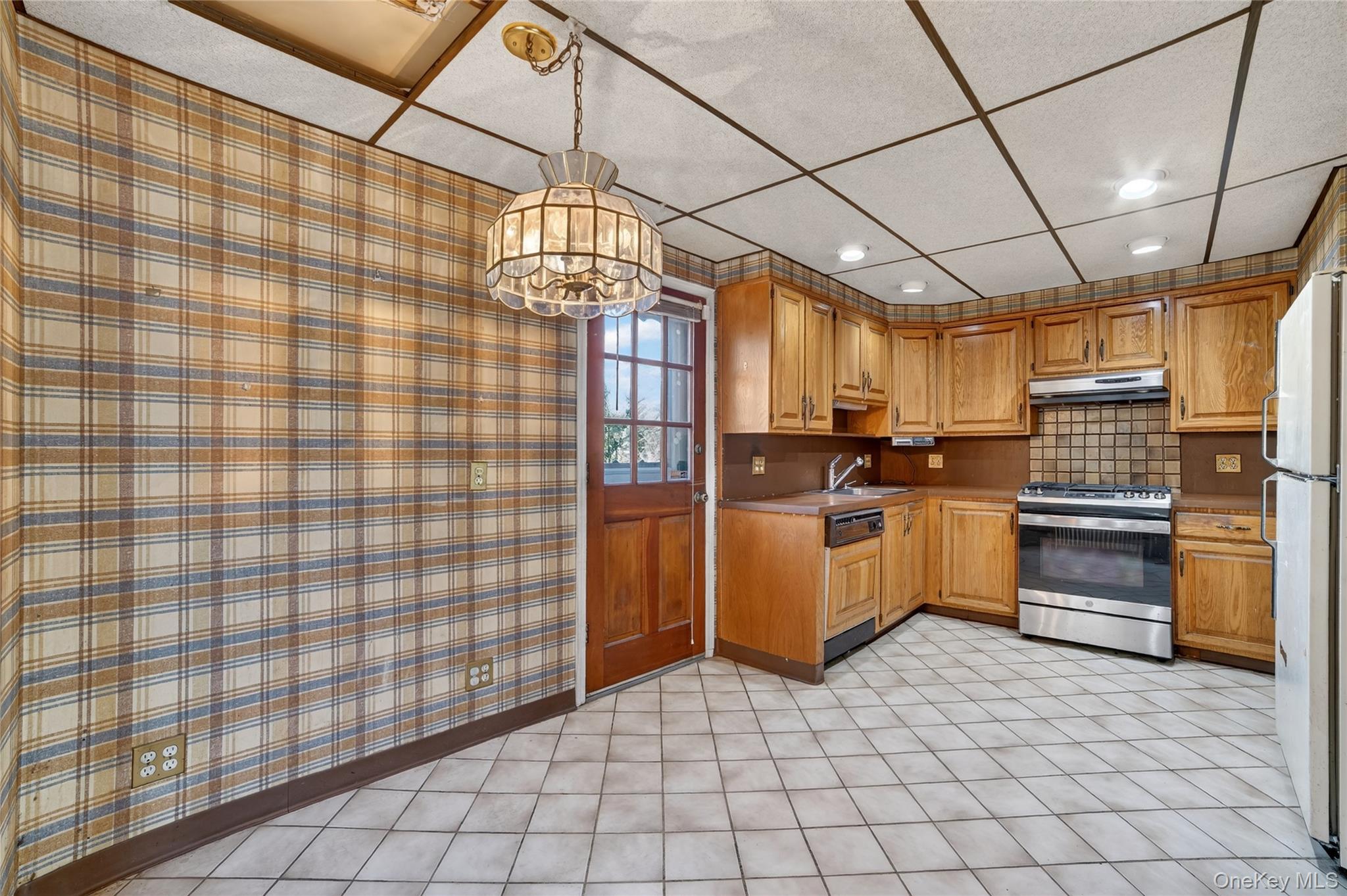 41 Devoe Street Dobbs Ferry, NY 10522 - Photo 10 of 28 a kitchen with cabinets and stainless steel appliances