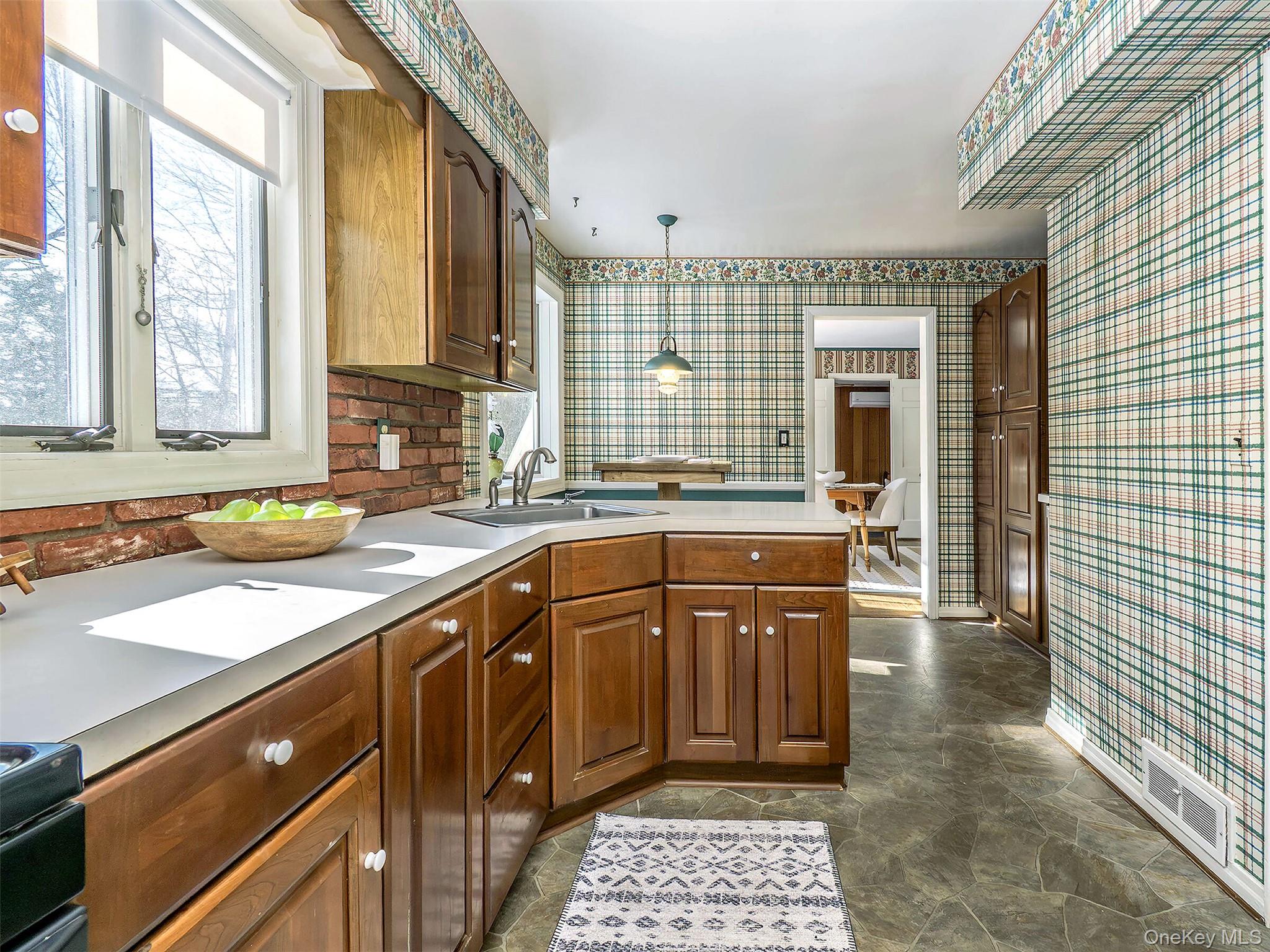 24 Orchard Farm Road Port Washington, NY 11050 - Photo 12 of 20 a kitchen with a sink stove and cabinets