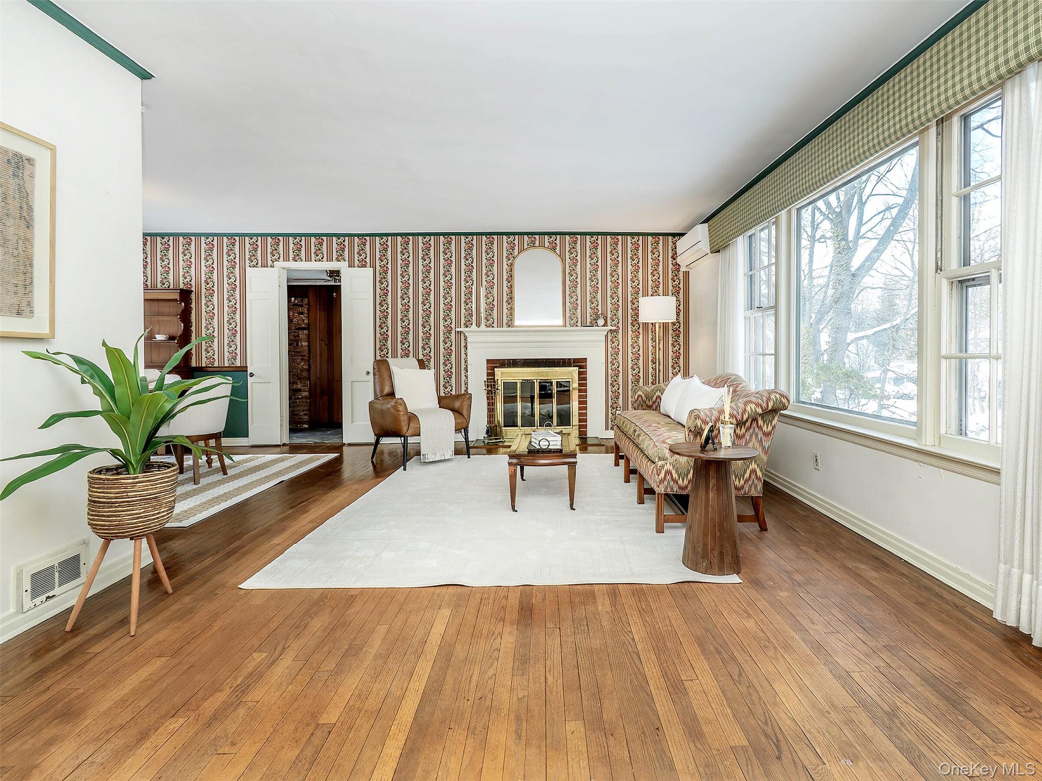 24 Orchard Farm Road Port Washington, NY 11050 - Photo 4 of 20 a living room with furniture and a fireplace