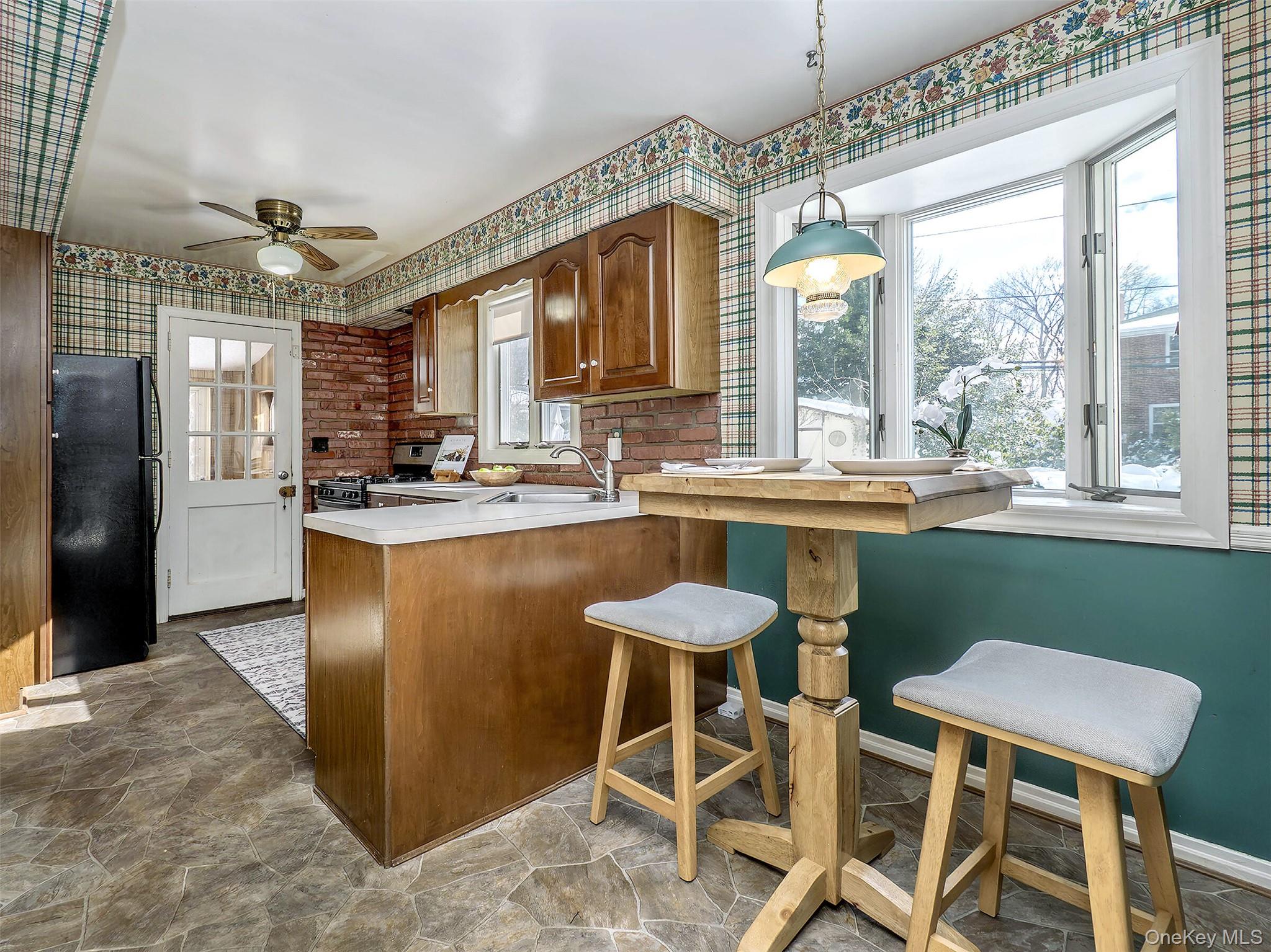 24 Orchard Farm Road Port Washington, NY 11050 - Photo 10 of 20 a kitchen with a table chairs sink and cabinets