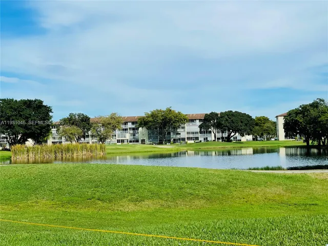 a view of swimming pool with a big yard and large trees