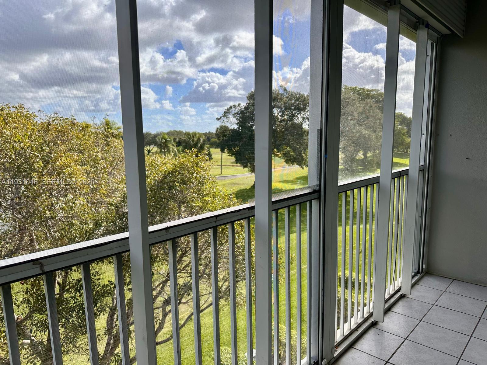 301 Southwest 135th Avenue, Unit 415C Pembroke Pines, FL 33027 - Photo 12 of 13 a view of a city from a balcony