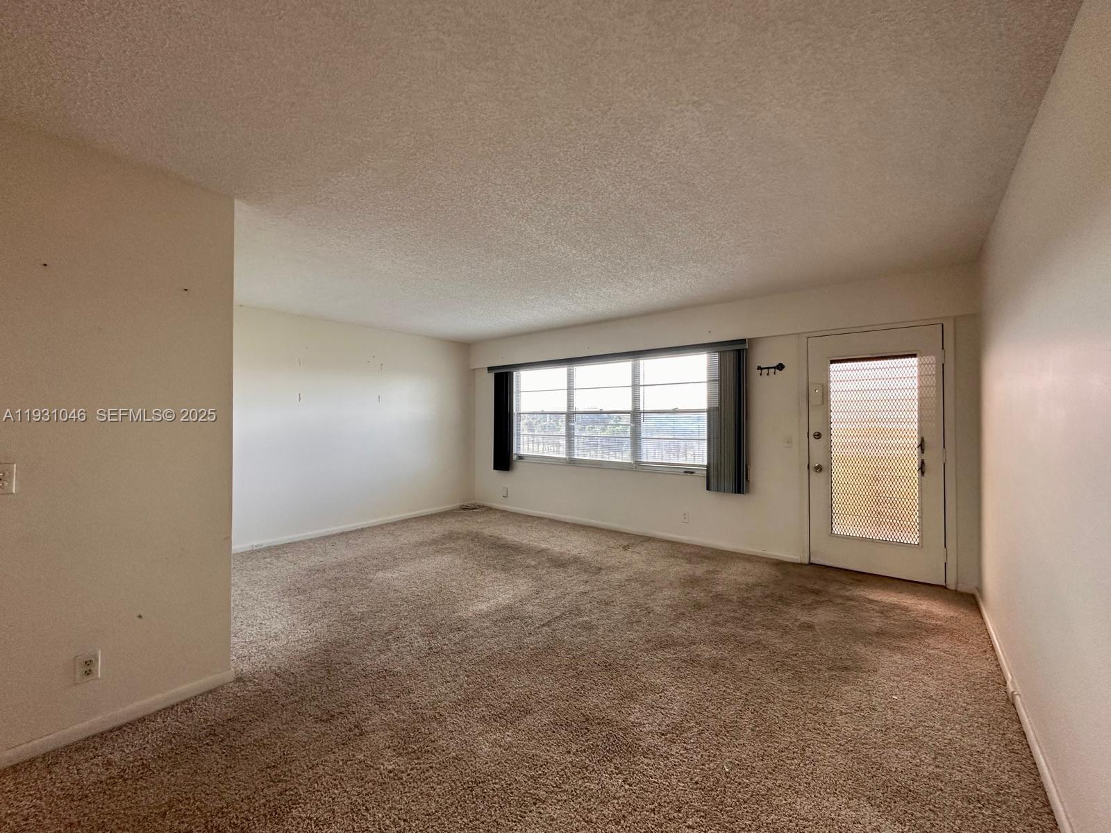 301 Southwest 135th Avenue, Unit 415C Pembroke Pines, FL 33027 - Photo 7 of 13 an empty room with windows