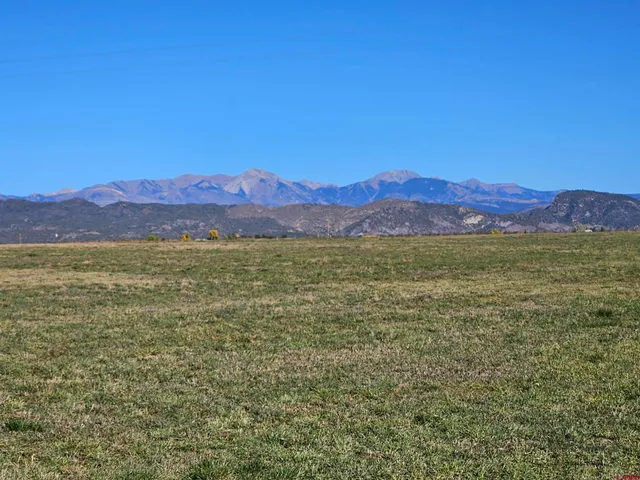 a view of an mountain with lake in the background